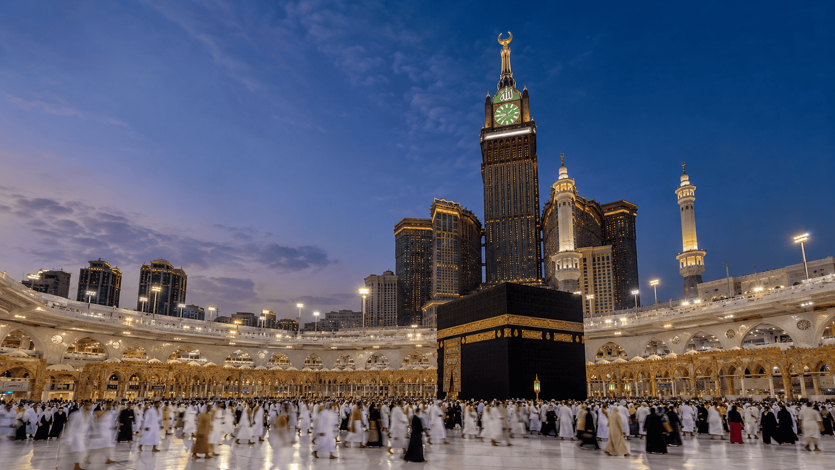The Holy Kaaba at Masjid al-Haram in Makkah with the Abraj Al Bait Clock Tower at blue hour
